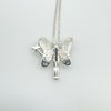Sterling silver fairy pendant from the back showing textured wings and chain