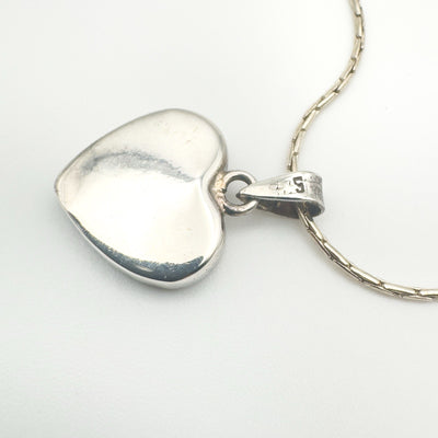 Reverse side of sterling silver heart pendant stamped 925 on the bail