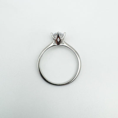 Sterling silver CZ solitaire ring laid flat showing full circle band
