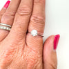 0.75ct CZ solitaire ring worn on hand with silver band