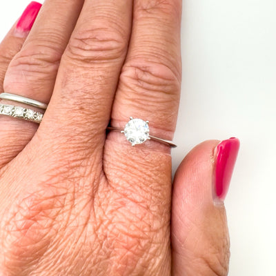 0.75ct CZ solitaire ring worn on hand with silver band