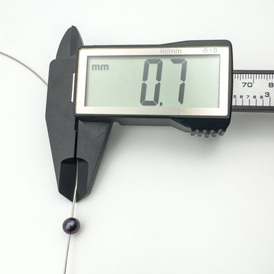 Necklace chain thickness measured at 0.7mm using digital calipers