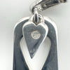 Close-up of diamond set in heart-shaped sterling silver charm