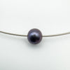 Close up of fixed black pearl on 9ct white gold modernist chain