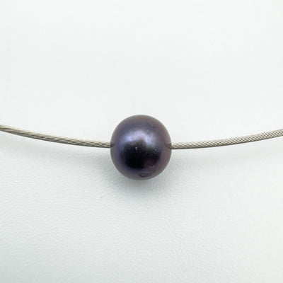 Close up of fixed black pearl on 9ct white gold modernist chain