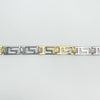 Detailed view of alternating gold and silver Greek Key links