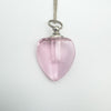 Close-up of mini pink glass heart perfume bottle pendant
