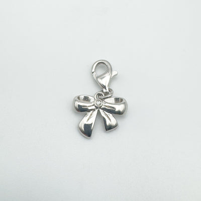 Front view of diamond set bow pendant in sterling silver