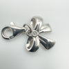 Close up of sterling silver bow charm with round cut diamond