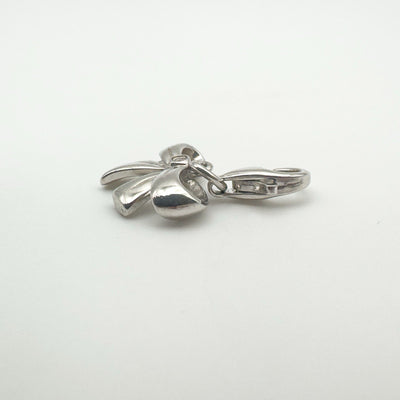 Side angle showing curved design of bow charm in silver