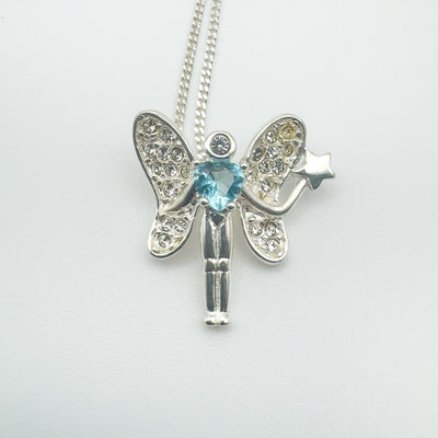 Front view of sterling silver fairy pendant with Blue Topaz heart and CZ wings on 18-inch chain