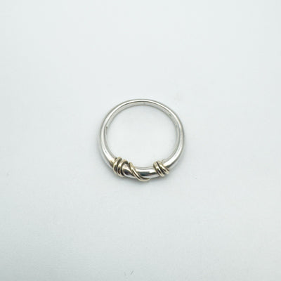 Full flat lay of twisted gold and sterling silver ring size L