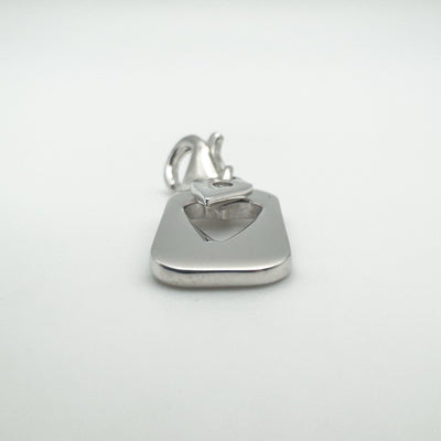 Flat-lay of sterling silver heart charm with lobster clasp