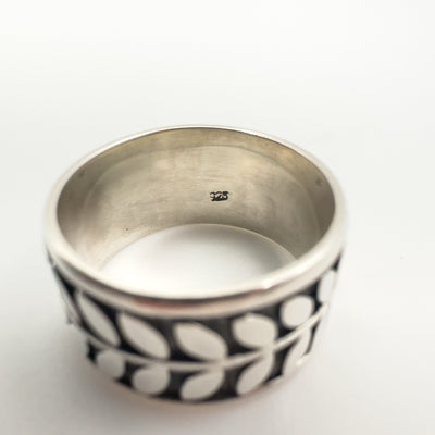 Close-up of 925 stamp inside wide sterling silver engraved ring