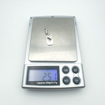 Silver heart pendant on scale showing 2.51g weight