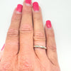 Twisted 9ct gold and sterling silver ring worn on finger