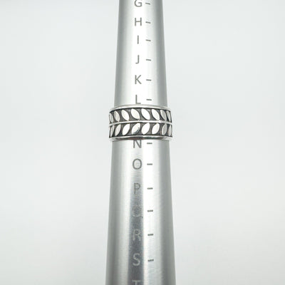Wide sterling silver ring on mandrel showing UK ring size L