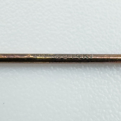Macro shot of "1/20 14K" stamp on rose gold earring stem