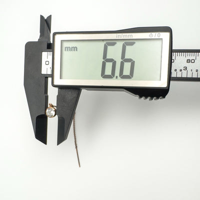 Digital caliper measuring a round cubic zirconia stone at 6.6mm