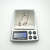 Pair of rose gold plated threader earrings on digital scale showing 1.15g total weight