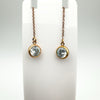 Pair of rose gold plated threader earrings displayed on a white stand