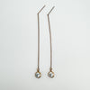  Full-length rose gold threader earrings with CZ stones laid flat
