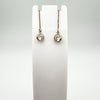 Rose gold threader earrings front-facing on white jewellery holder