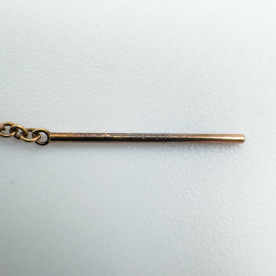 Close-up of hallmark "1/20 14K" on rose gold threader earring post