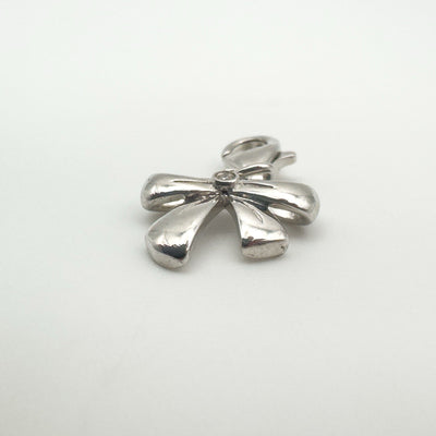Sterling silver bow charm showing diamond centre detail