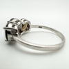Angled side view showing prong setting and silver band of Smokey Quartz trilogy ring