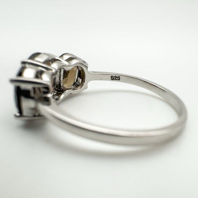 Angled side view showing prong setting and silver band of Smokey Quartz trilogy ring