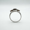 Side profile of trilogy ring showing depth and raised setting of three Smokey Quartz gems
