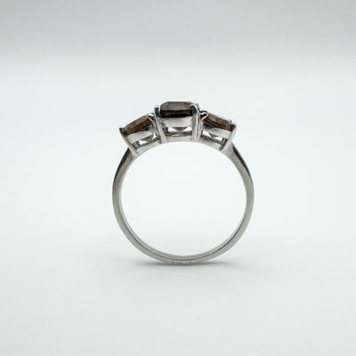Side profile of trilogy ring showing depth and raised setting of three Smokey Quartz gems