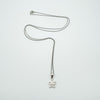 Sterling silver necklace with a small flower pendant laid flat on a white background.
