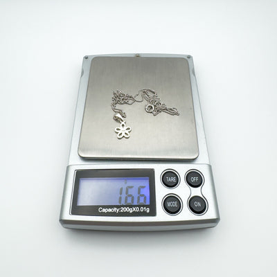 Necklace on digital scale showing weight of approximately 1.6g.