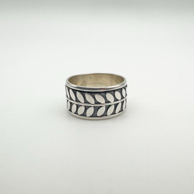 Sterling silver band ring with repeating leaf motif design
