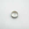 Top view of sterling silver band ring with rotating leaf design