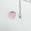 Pink heart perfume bottle with removable screw-top cap