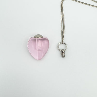 Pink heart perfume bottle with removable screw-top cap