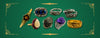 Gold, silver and platinum vintage rings with sapphire, amethyst, opal, smokey quartz and diamond on green background