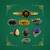 Gold and silver vintage rings with gemstones including sapphire, amethyst, opal, smokey quartz and diamond on green background