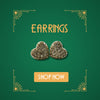 White gold heart-shaped diamond earrings on green background with art deco corners and Shop Now button