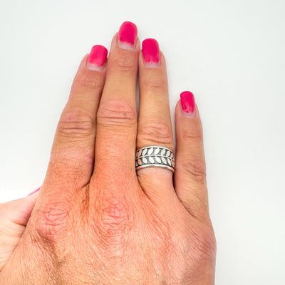 Sterling silver leaf engraved ring shown worn on finger, size L
